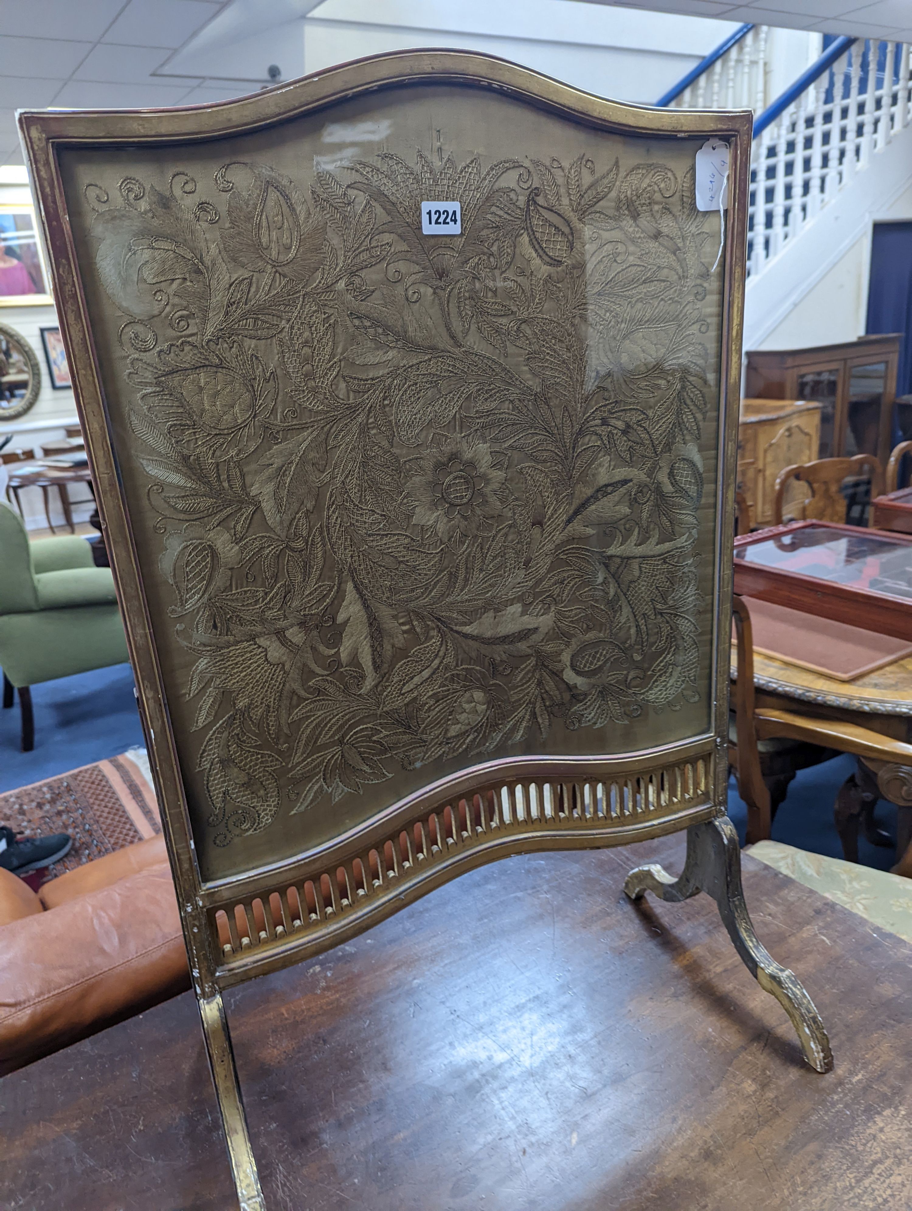 An Edwardian carved giltwood and needleworked firescreen, width 56cm, height 91cm